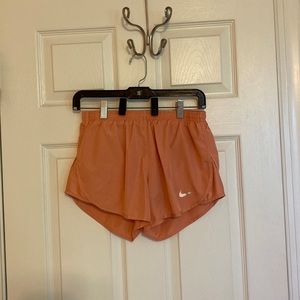 Orange Nike running shorts with built in underwear